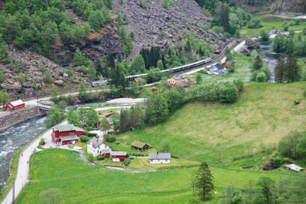 View from Brekkefossen Waterfall towards Haugen Gård in Flåm. Do you see the train on the Flåm Railway?